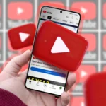 Một bàn tay đang cầm điện thoại hiển thị logo YouTube, minh họa tính năng playlist cộng tác.