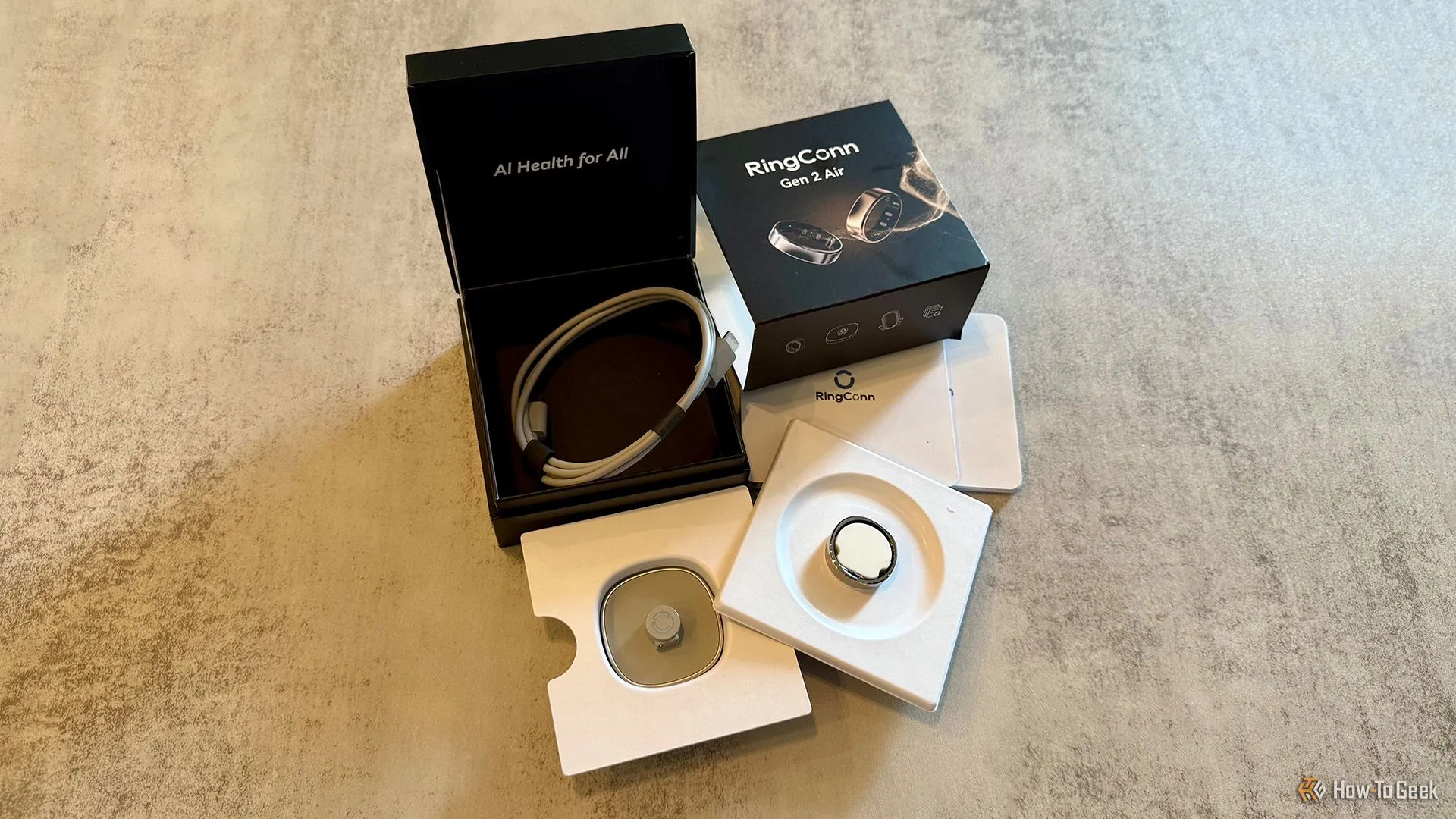 Toàn bộ phụ kiện đi kèm khi mua RingConn Gen 2 Air, bao gồm vòng, đế sạc, cáp USB-C và tài liệu hướng dẫn.